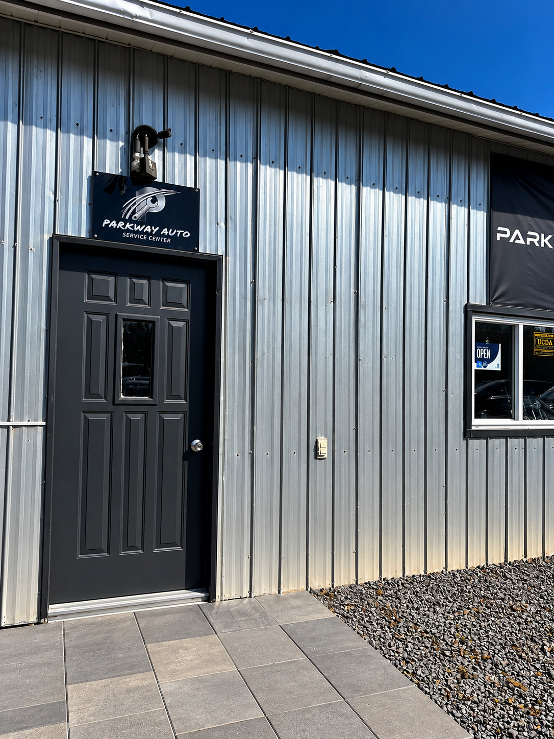 Parkway Auto Service Center entrance with black door and shop sign