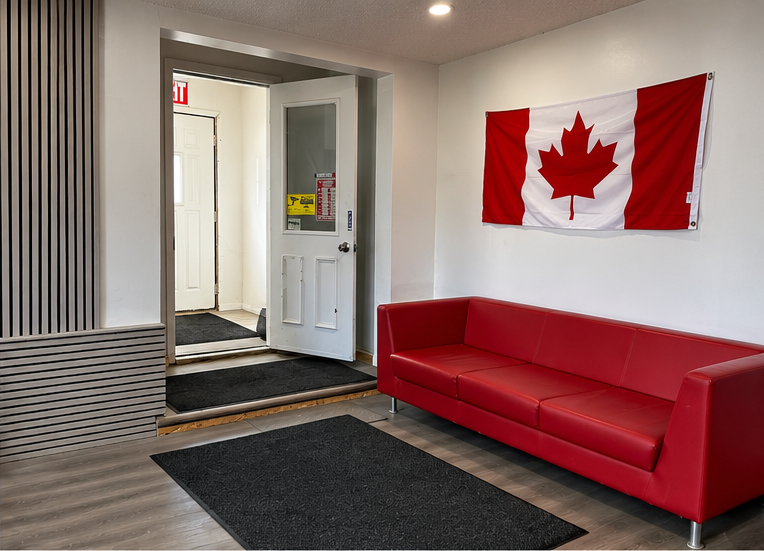 Customer waiting area with a red sofa and Canadian flag